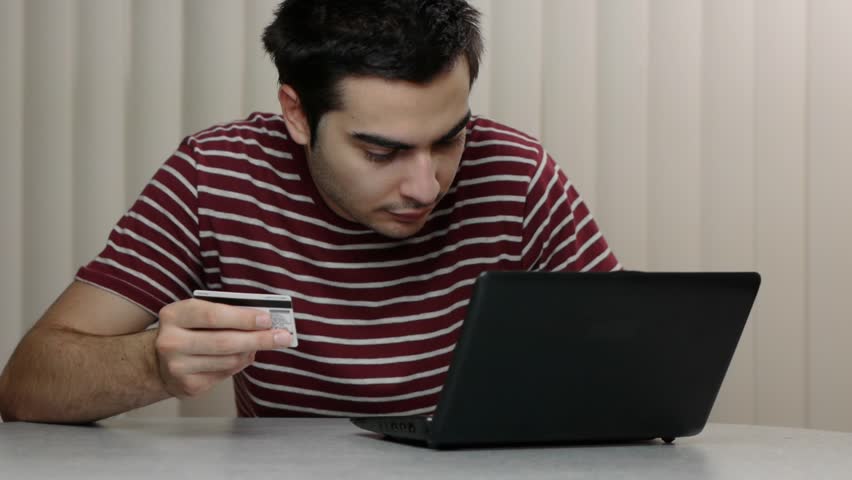 Young man with a t-shirt using a laptop PC computer
