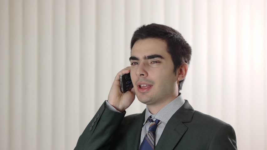 Businessman talking to his smartphone cellular device