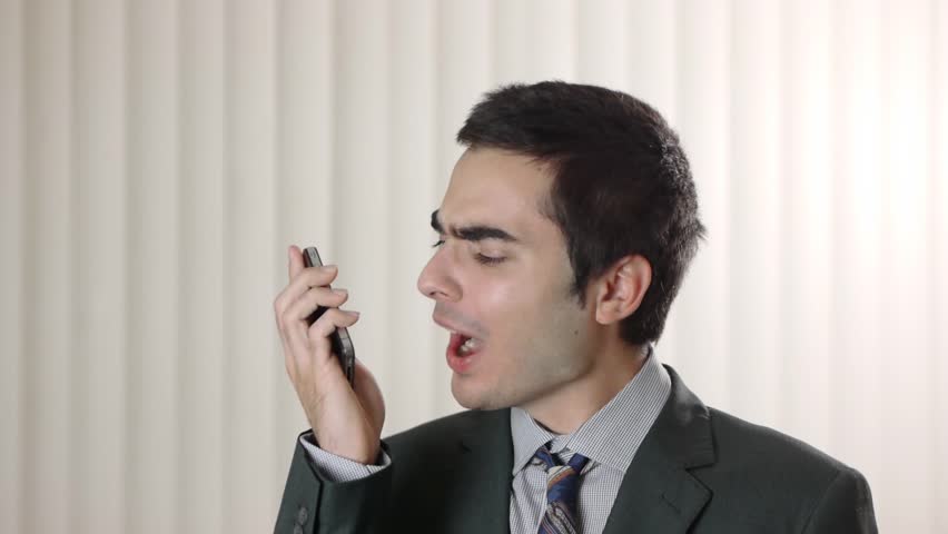 Frustrated man yelling at his smartphone