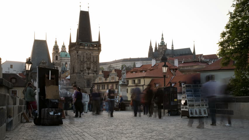 Ending day on Charles bridge in Prague during with artists and traffic of walking people. Time lapse. 30 fps progressive version.