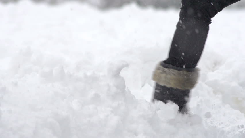 Slow Motion Of Woman's Leg Wearing Snow Boots Kicking Fresh Snow