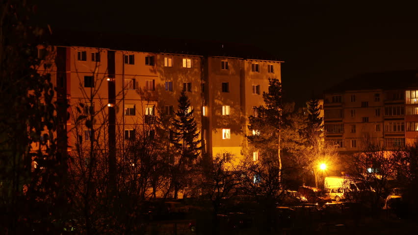 4k timelapse (4096x2304) with evening and nighttime activity around the neighbourhood block apartaments, the people on flats, streets lights.