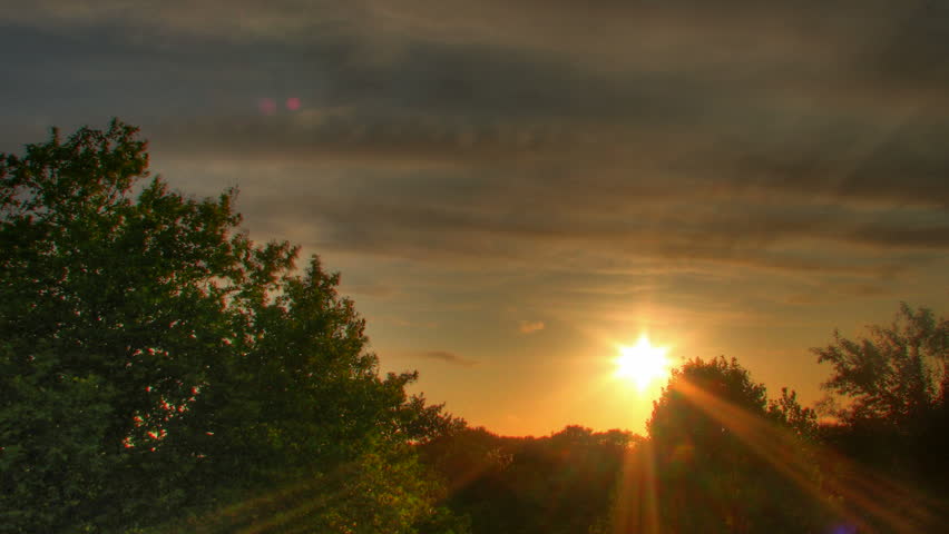 Sunset over trees, HD time lapse clip, high dynamic range imaging