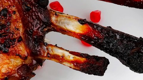 ribs served on plate with pomegranate seeds1920x1080 intro motion slow hidef hd