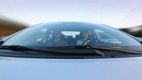 Timelapse of driving during day with camera mounted on vehicle hood. Young man and woman are in the car.		  - Powered by Shutterstock - Get 15% off with code: PIKWIZARD15