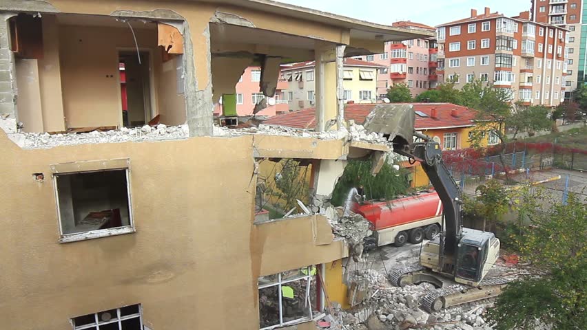 Demolition of a house with a digger. Turkey sits on a vulnerable fault line and
