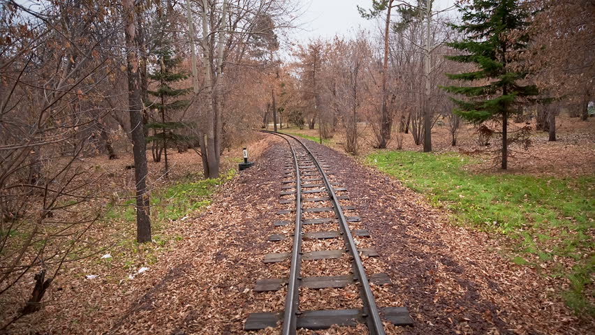Walk Along The Rails, Man and woman walking in the autumn park 