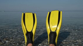 Looking through a pair of flippers at a water skier