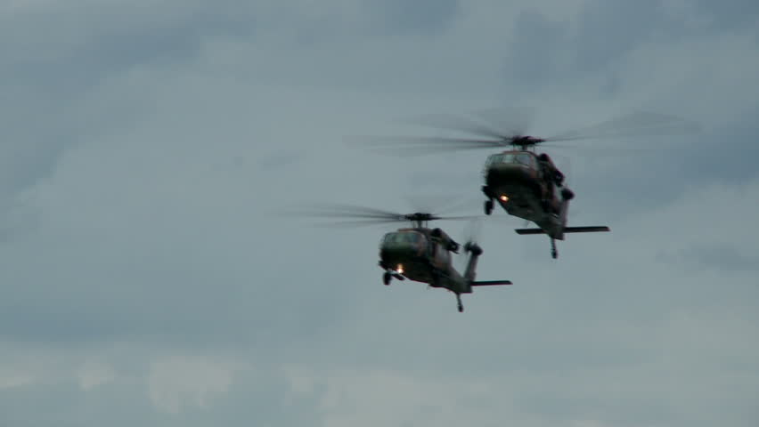 Two blackhawk helicopters fly in formation