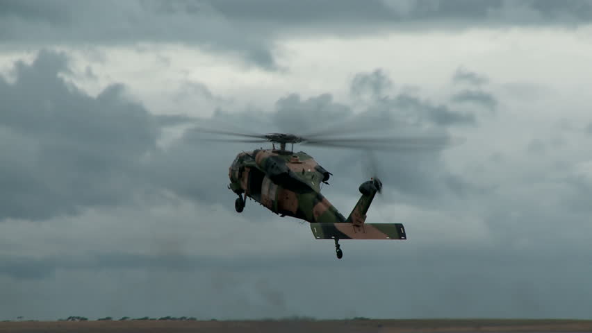A blackhawk helicopter transitions to the landing phase