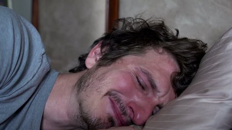 Very upset man crying in bed