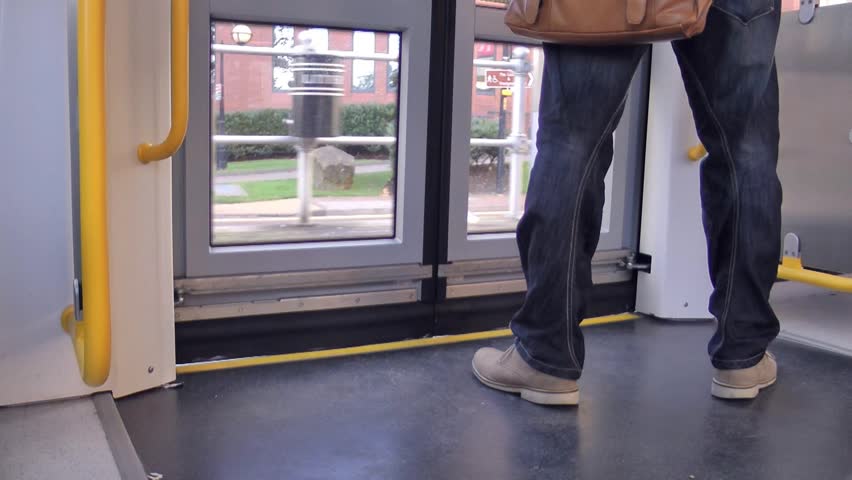 Manchester - Circa 2013: Passenger exits through tram doors on the Metro