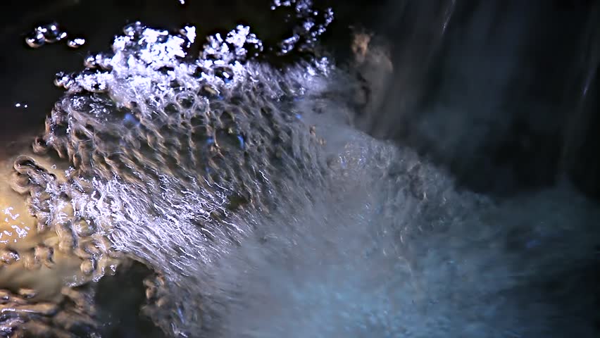 water flowing in the stream with bubbles
