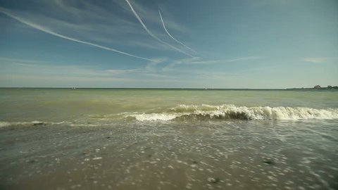 Waves washing shore sands.