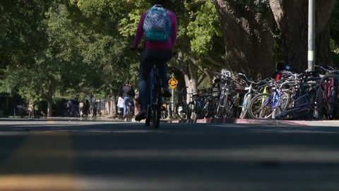 Students coeds on bicycle bikes near school college campus HD HIGH DEFINITION STOCK VIDEO FOOTAGE 1920X1080