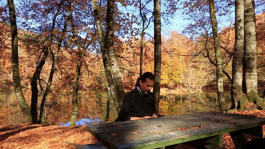 depressed man smoking in the park