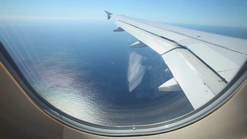 view of airplane wing through plane window