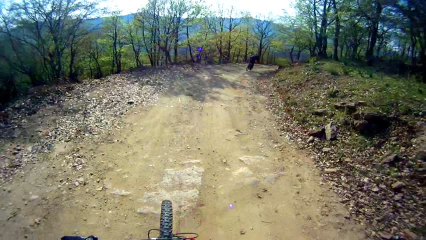 Mountain bike downhill sport race Stock Video. Back view of the other biker pov