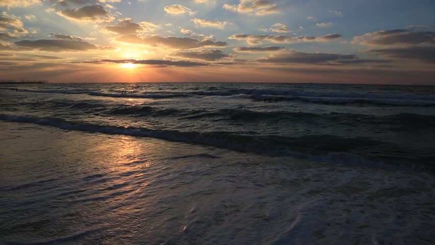 Beautiful sunset at the beach, amazing colors, light beam shining through the cloudscape over the arabian gulf seascape, united arab emirates. Dubai sea and beach