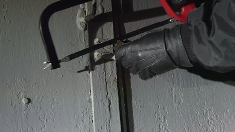 Burglar cut away the padlock on the gate of the garage at night