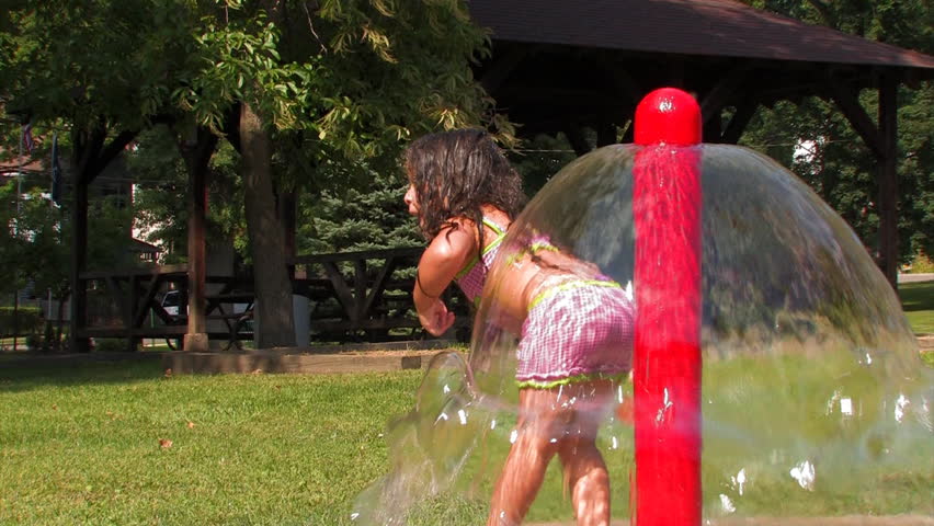 A young child plays in the water.