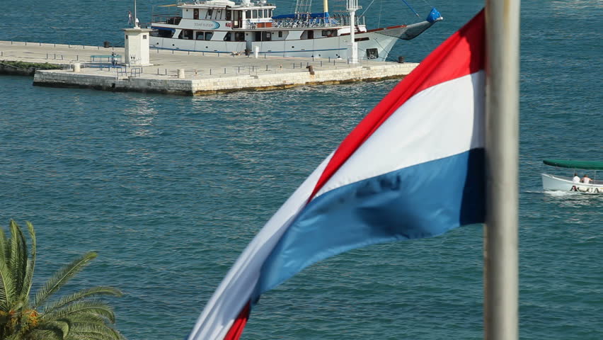 SPLIT, CROATIA - JULY 24, 2013: View of harbour and Croatian flag on July 24, 2013 in Split, Croatia. Split is the largest city on the Dalmatian coast.