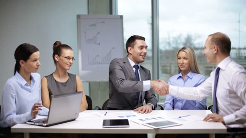 business handshake concept - businessmen signing a contract and shaking their hands