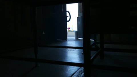 BMX rider going into dark warehouse Stock Video