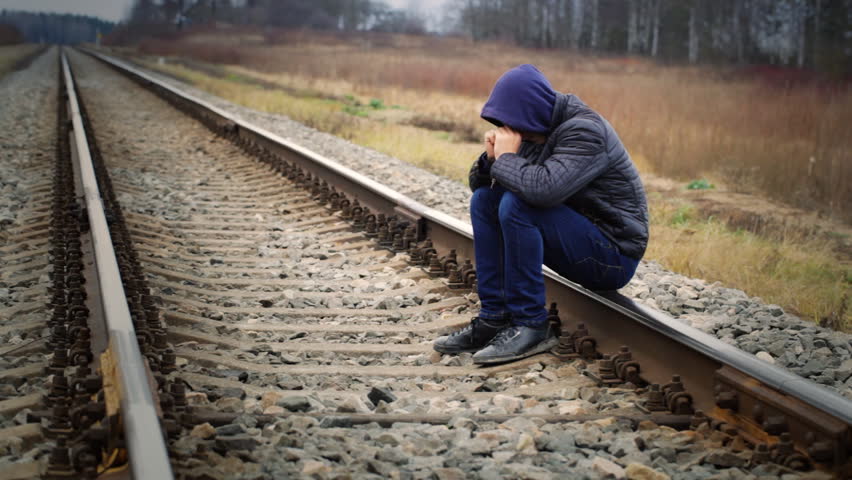 Sorrowful boy on the railway Royalty-Free Stock Footage #5168333