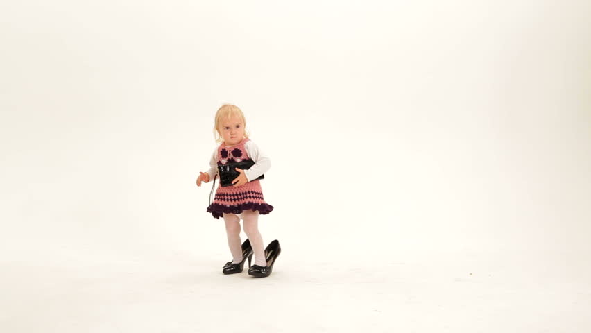 Little snappy dresser with a purse wearing high heels.
Snappy dresser.