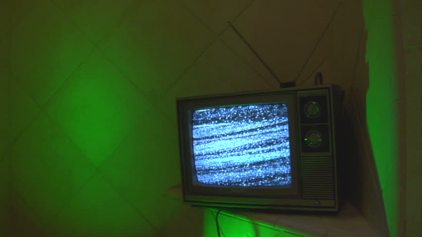 This retro TV is on a strange green tile background that transitions to blue.