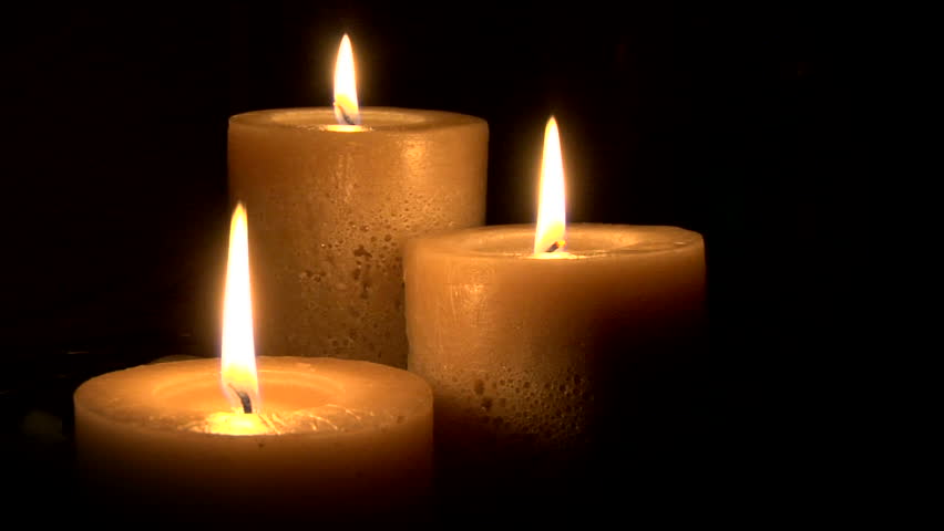 this is a seamless loop of 3 warm candles gently burning in a black void.  I