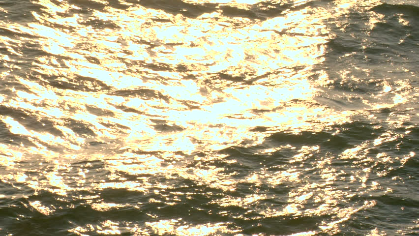 This is a highspeed/slow motion shot of a golden sunset reflecting off of a