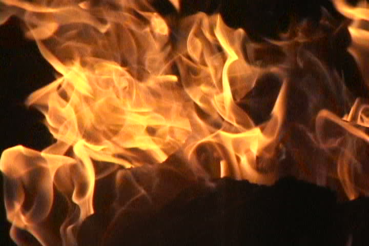 Close up of fire burning on black background.