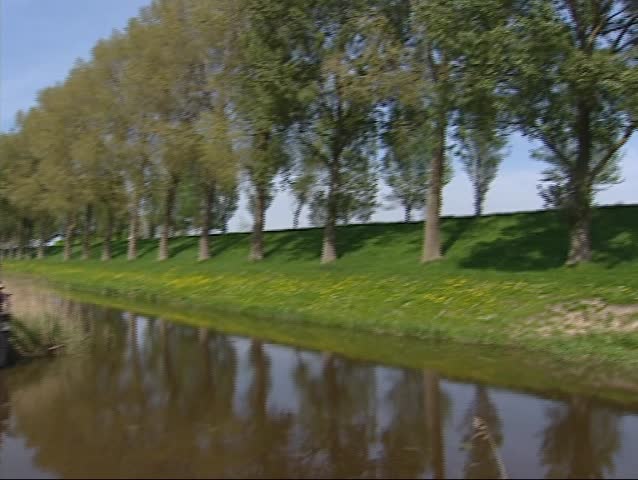 Canal + pan - dike with row of trees in straight line near Hoofddorp,The Netherlands, part of the UNESCO World Heritage site Defence Line of Amsterdam. 