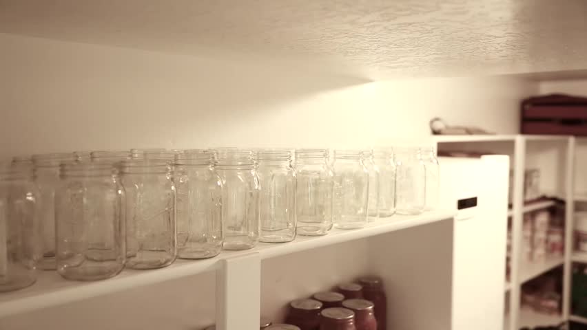 Food canned in mason jars on shelves in a storage room in the basement