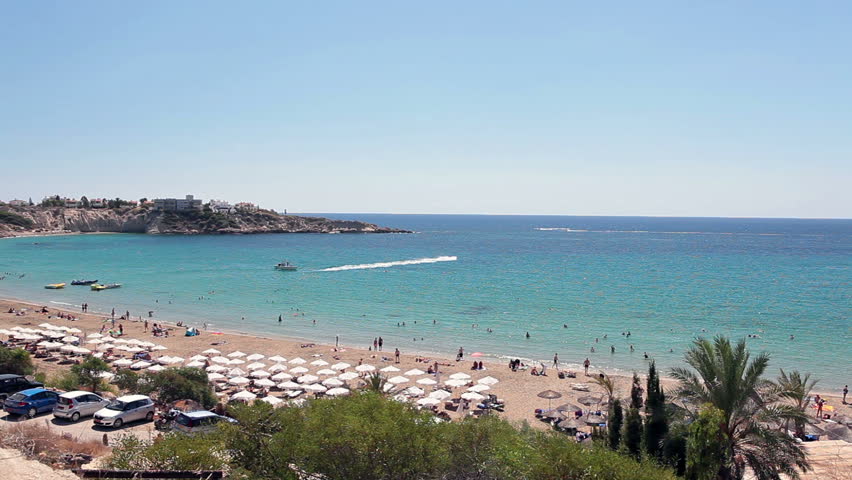 Mother and daughter standing together on viewing platform in Coral Bay beach and looking at Mediterranean seaside, Paphos, Cyprus