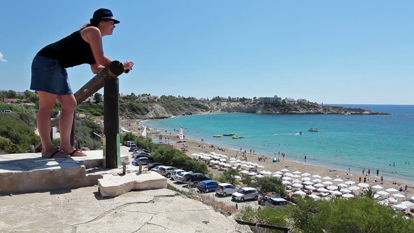Mother and daughter standing on observation deck in Coral Bay beach and looking at Mediterranean seacost, Paphos, Cyprus