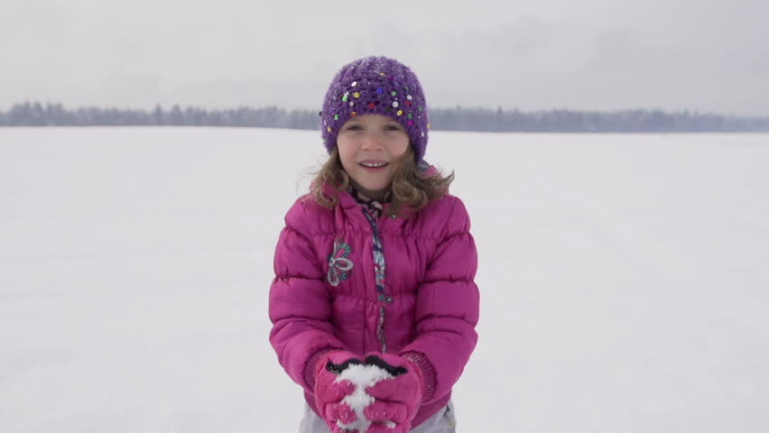 Slow Motion Of A Cute Girl Throwing Fresh Snow Up In The Air 