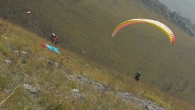 Paraglider running and taking off hill at Remeata, Romania