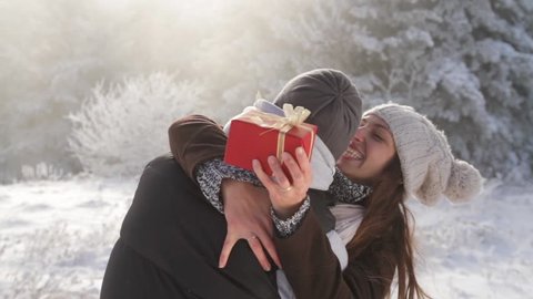 Pretty Young Woman Hugging Boyfriend Christmas Present Winter