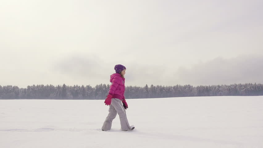 Slow Motion Of Mother, Daughter And Son Trudging Through Fresh Snow On A Winter