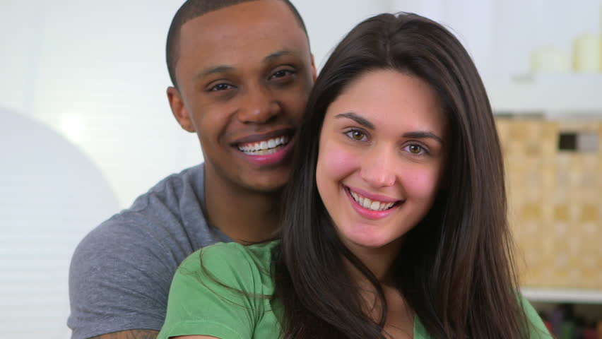 Portrait of happy young African American and Caucasian couple