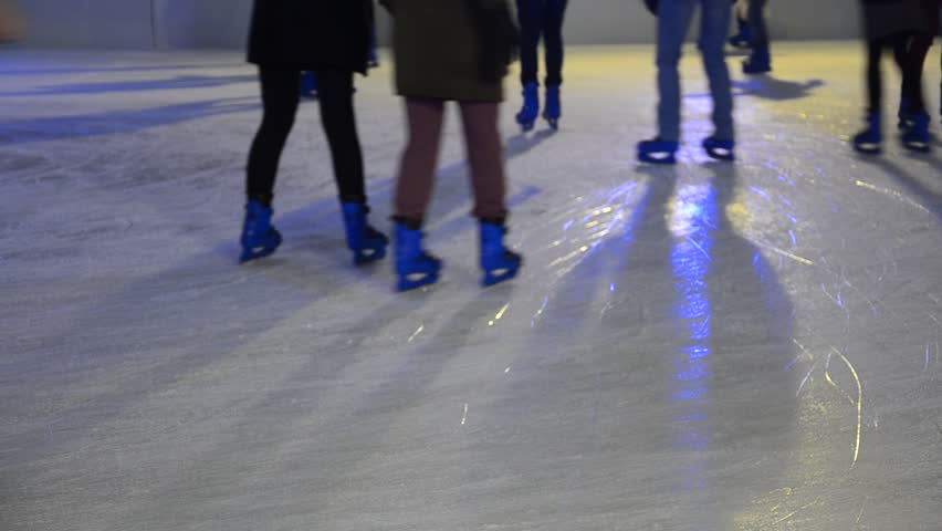 crowd of Ice skaters at a public ice skating rink, Medium Shot, Front and side