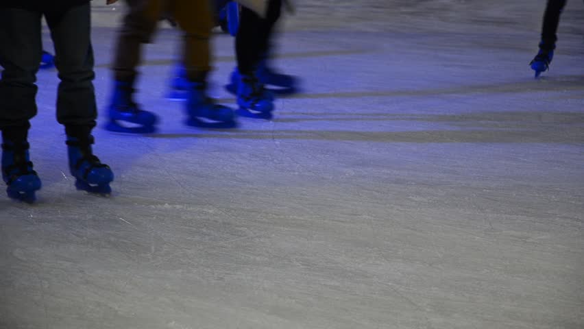 crowd of Ice skaters at a public ice skating rink, Medium Shot, Side View