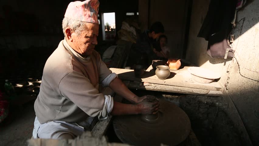 BHAKTAOUR, NEPAL - DEC 7: Unidentified Nepalese man working in the his pottery