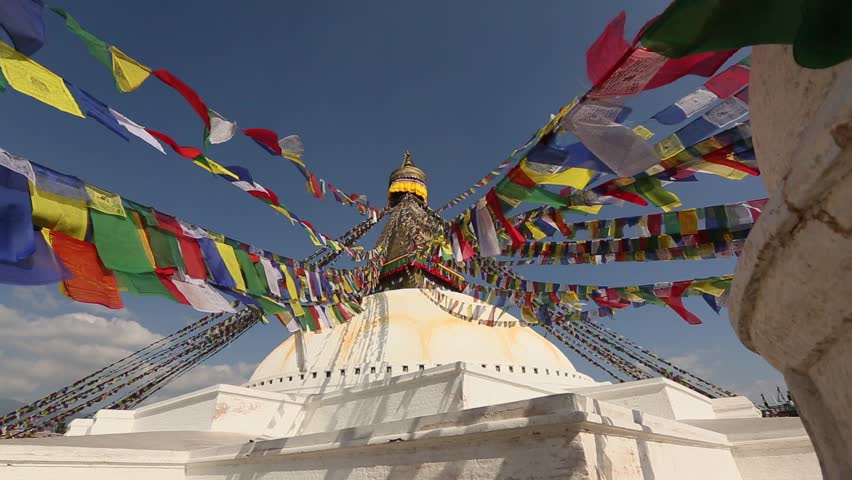 Colored flags fly near Boudha or Bouddhanath stupa in Kathmandu, Nepal (HD)