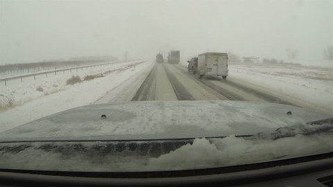 UTAH, 3 DEC 2013: First winter snow blizzards hit West and Midwest causing accidents and dangerous roads. Interstate highway traffic POV. Snow packed and icy roads and highways. 