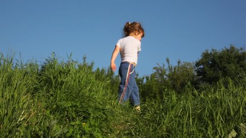girl exercising on meadow 