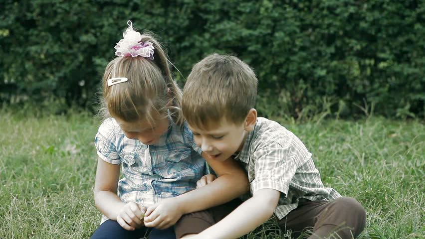 Two child speaking  in park, outdoors